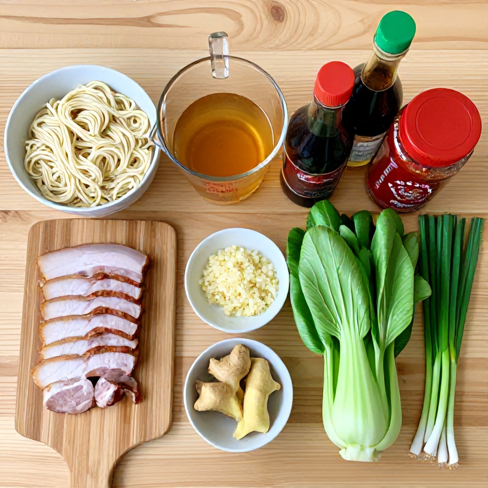 Raw ingredients for hot and sour noodle soup laid out on a wooden surface