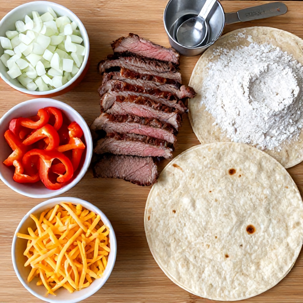 Raw ingredients for Steak Cheese Quesadillas arranged on a wooden surface