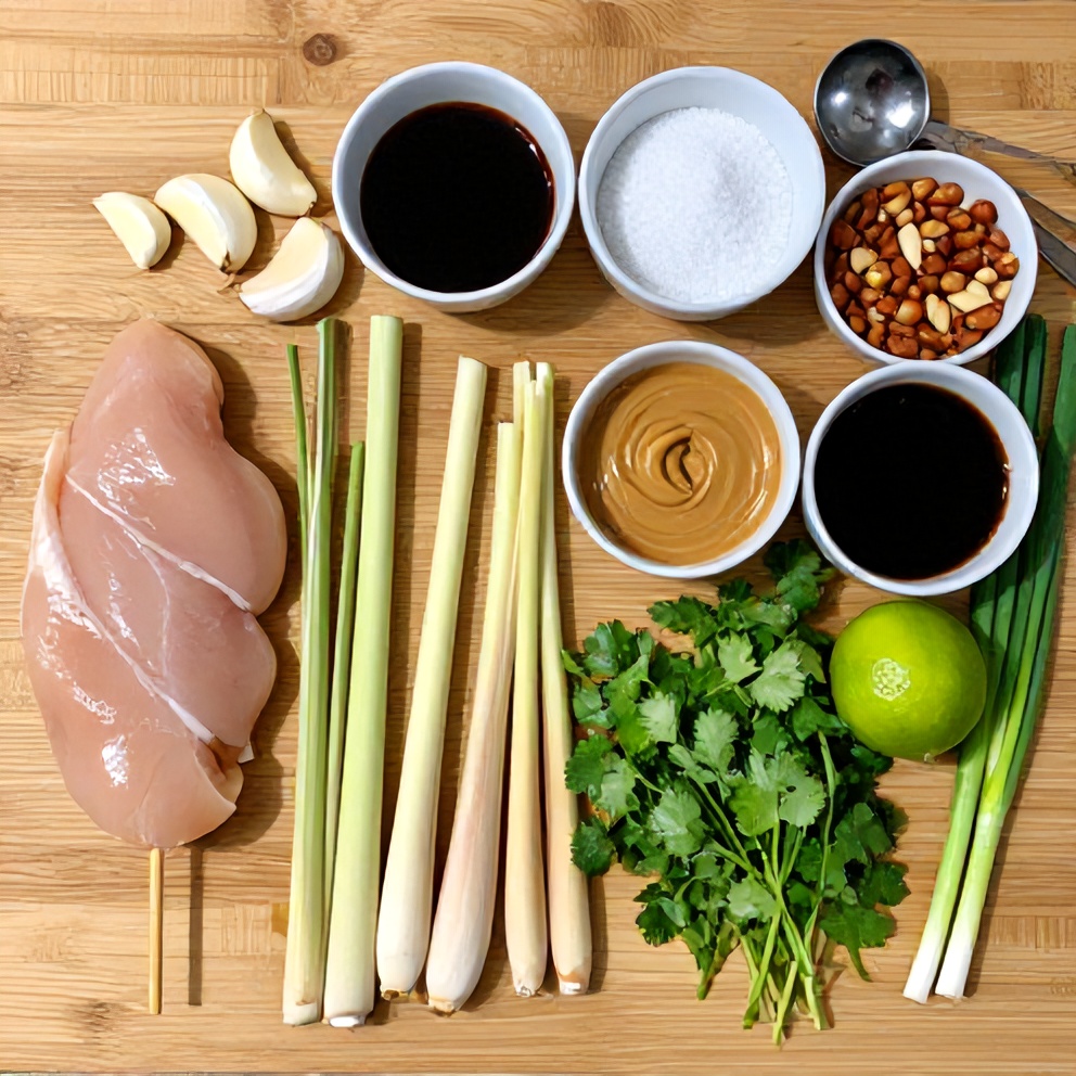 Raw ingredients for Vietnamese lemongrass chicken skewers laid out on a wooden surface