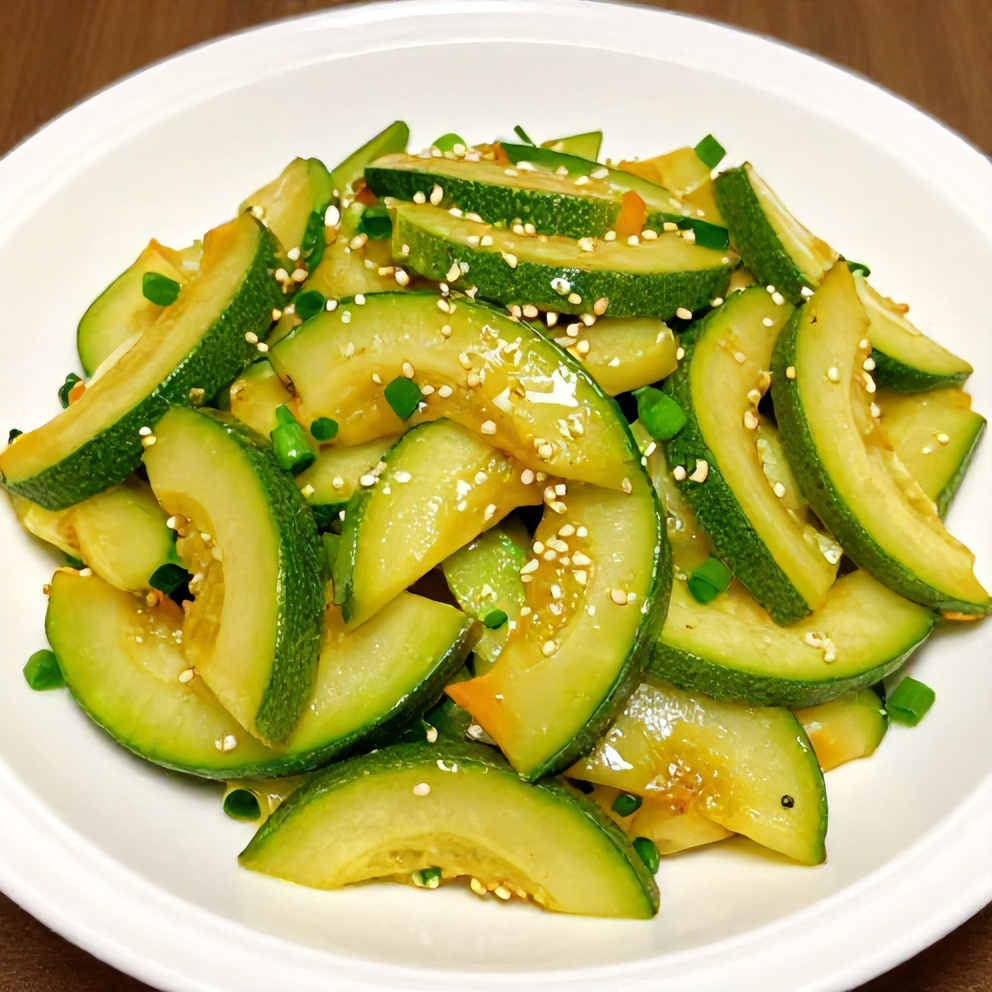 Plated zucchini stir fry with green onions and sesame seeds