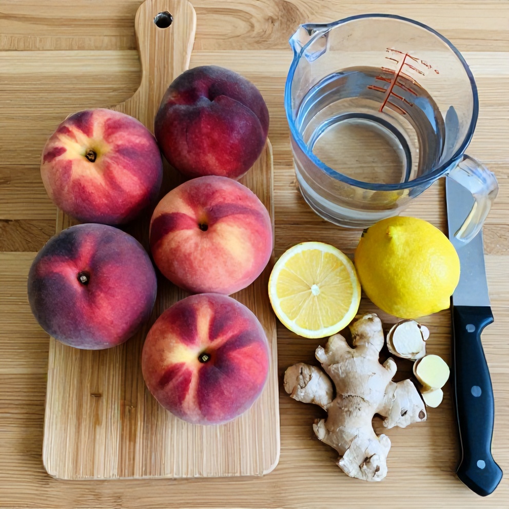 Raw ingredients for peach ginger lemonade on a wooden surface